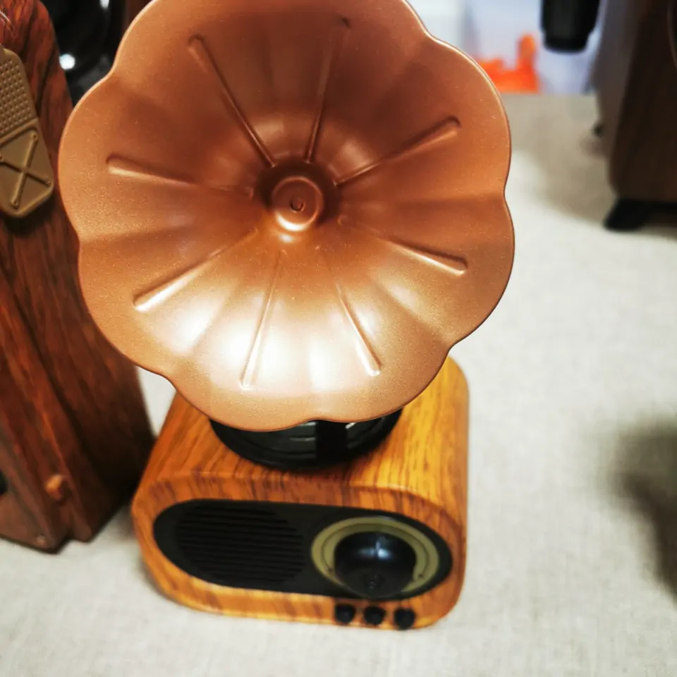 Flower-shaped horn on a compact wood-finish speaker