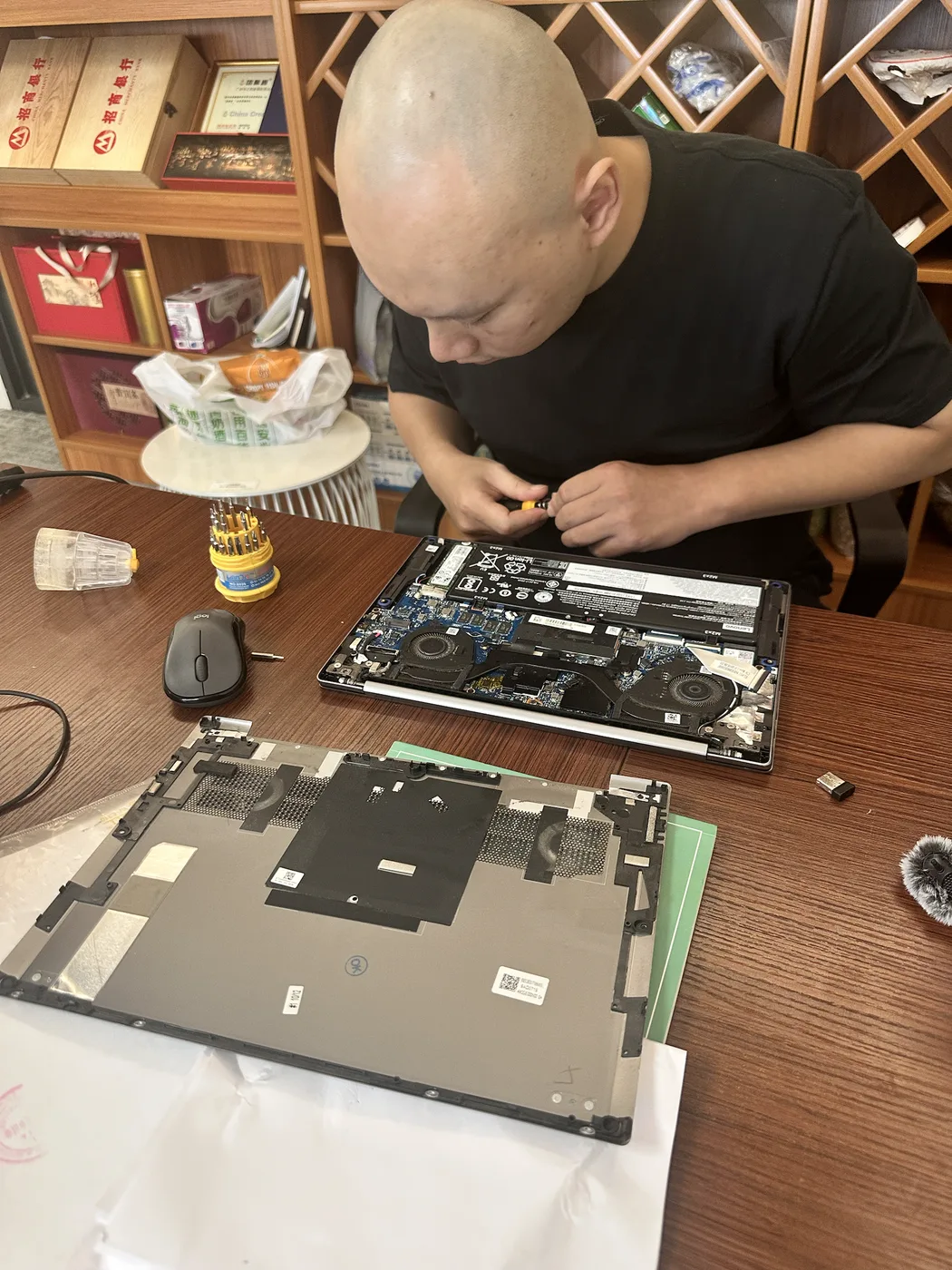 Technician opening an electronic device for a hands-on model and component check